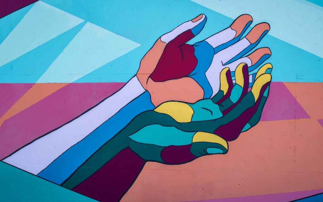 Illustration of hands cupped together upward that are of many different colors with a background of assorted shapes of different colors.