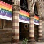 Banners outside a church with rainbows on them and the words, “Mercy. Justice. Beauty.”