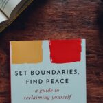 A book sitting on a table with the title, “Set Boundaries, Find Peace.”