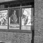 Nazi propaganda election posters on the windows of a storefront in Austria in 1938.