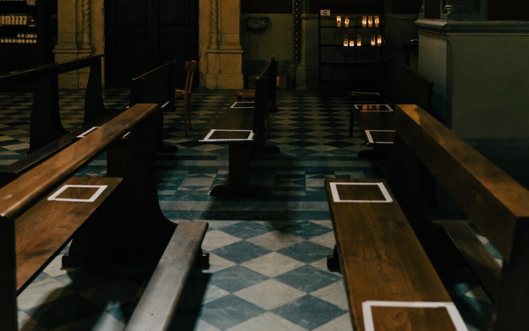 Squares taped onto benches to promote social distancing St. Margaret's Church in Cortona, Tuscany, Italy.