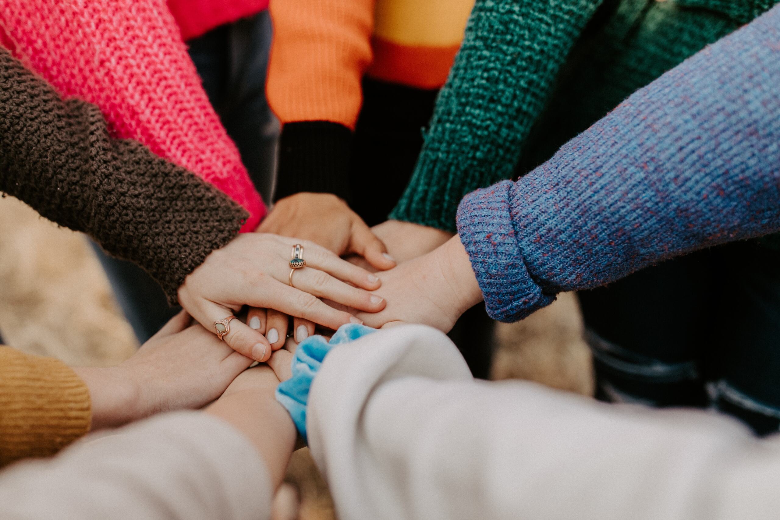 A group of people with their hands piled on top of each other.