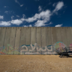 A wall in Gaza with graffiti on it.