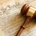 A photo of a gavel on a copy of the preamble to the U.S. Constitution.