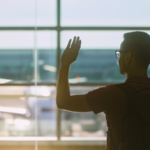 A man waving goodbye at the airport