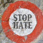 The words “Stop Hate” painted in a bullseye on concrete