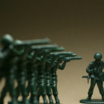 A photo of a line of toy soldiers ready to shoot.