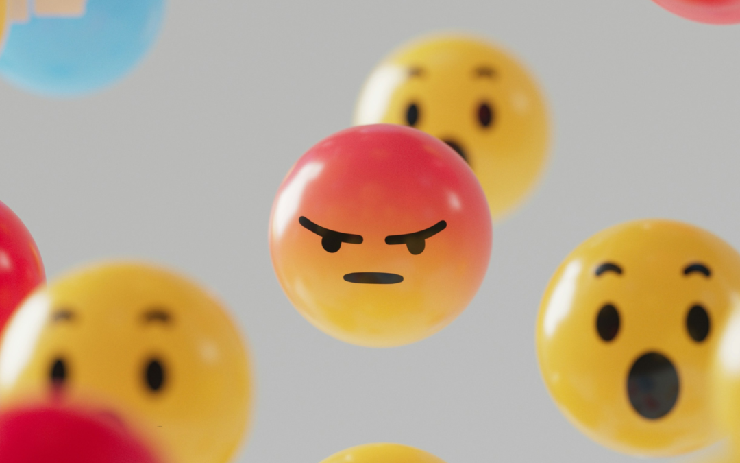 The Facebook “angry” emoticon floating in air with other emoticons.