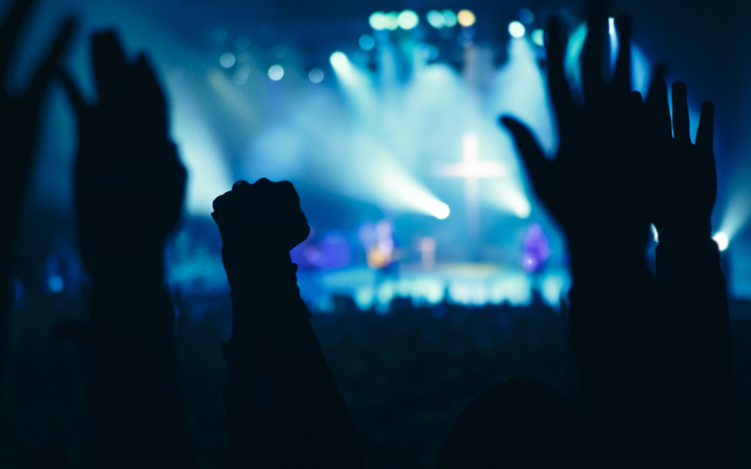 Hands lifted in a contemporary worship service.