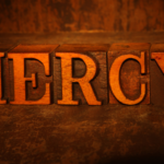 The word “Mercy” written on wooden blocks.