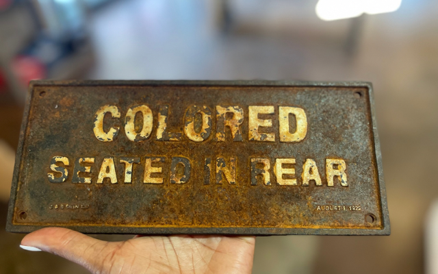 A segregation sign that reads, “Colored Seated In Rear” from a collection at the Penn Center on St. Helena Island in South Carolina.