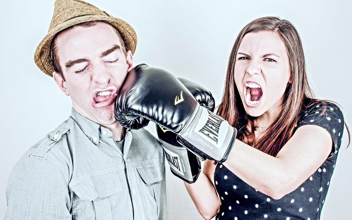 Woman with boxing gloves punching a guy