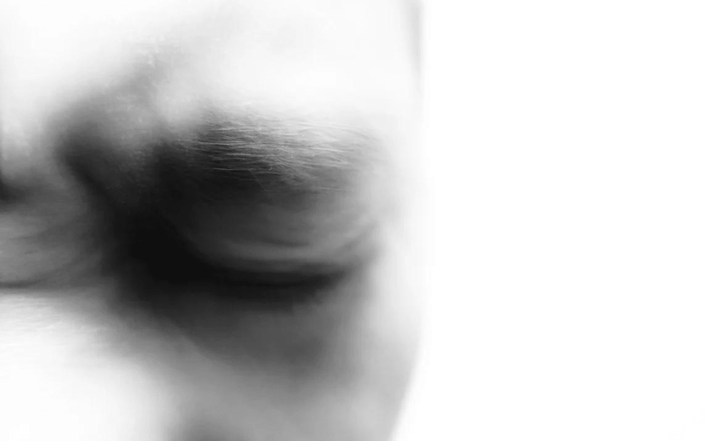 Man’s face with furrowed brow in black in white.