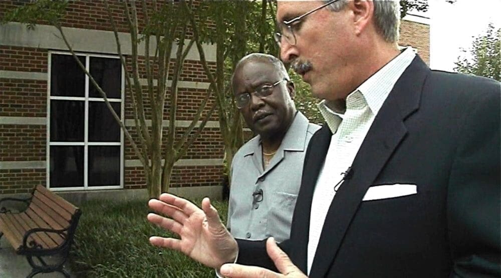 Two men walking and talking