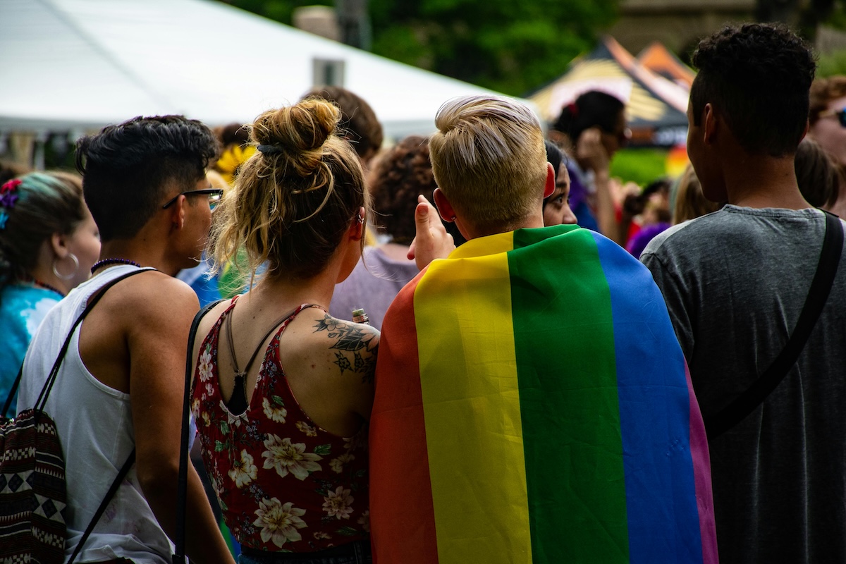 pexels-brett-sayles-1167034 A photo of a female couple waving pride flags at a Pride celebration.
