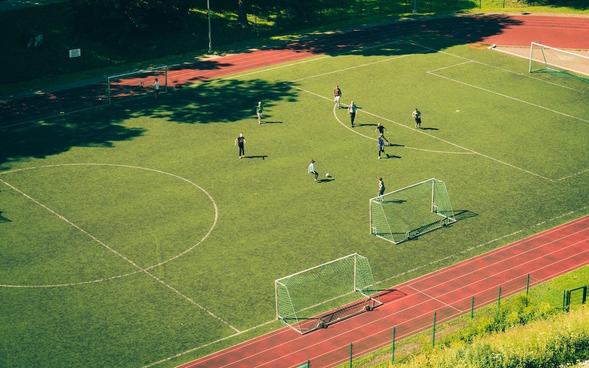A soccer field with players on it seen from above.