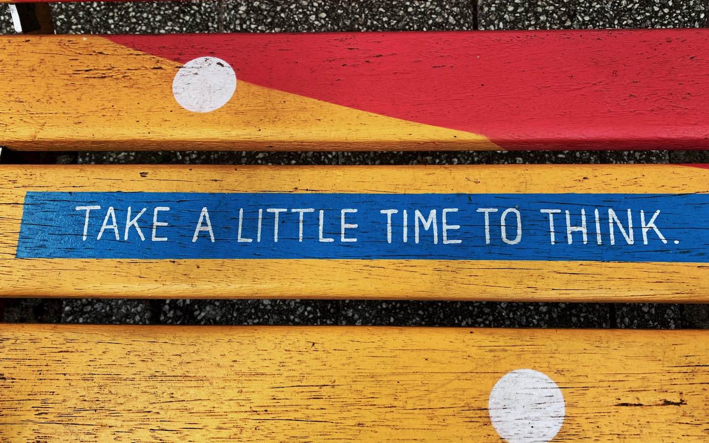 A wooden bench with the words