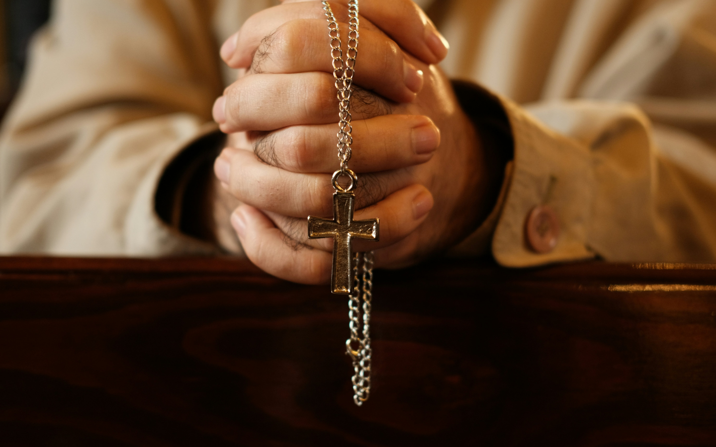 Hands holding a rosary.