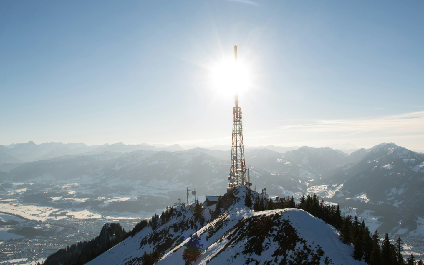 A television tower on a snowy mountain.